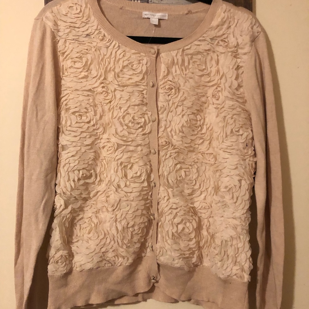 Woman’s large button up sweater/cardigan. Beautiful floral detailing on front.